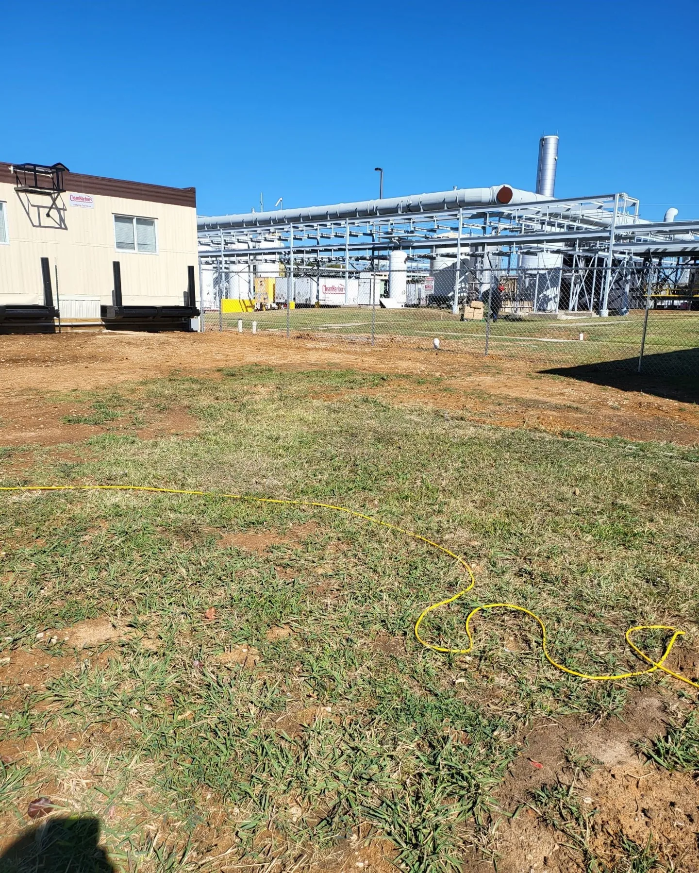 Chain-link perimeter around industrial equipment